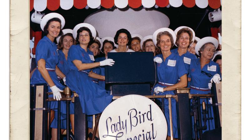 Photograph of women in blue dresses with Lady Bird Johnson