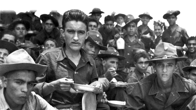 Group of Latino American soldiers sitting and resting between training maneuvers