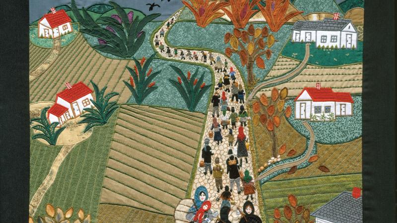 Quilt depicting people leaving a village by a road