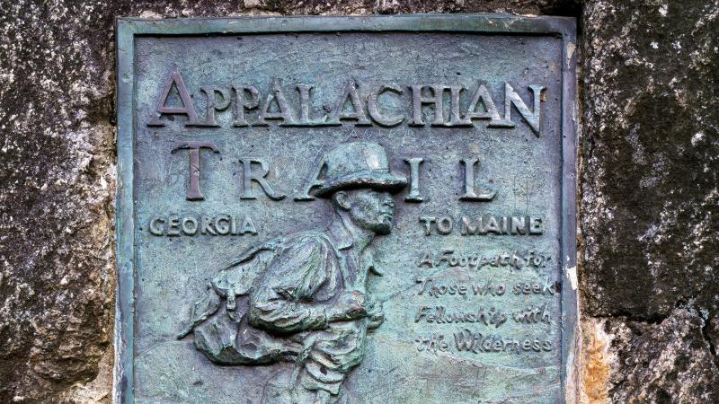 Photo of a dark green plaque which marks the beginning of the Appalachian trail.