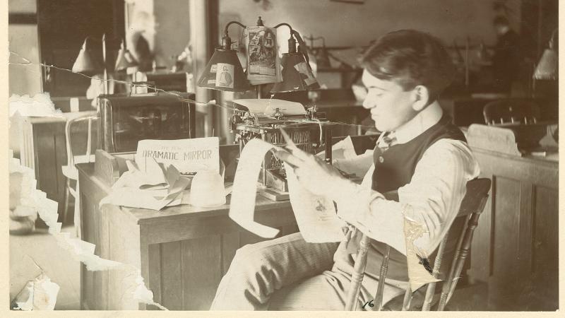 Photograph of H.L. Mencken sitting at his desk at The Baltimore Herald.