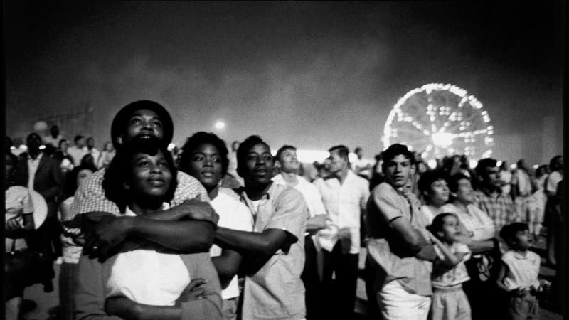Coney Island crowd, with the ferris wheel in the background