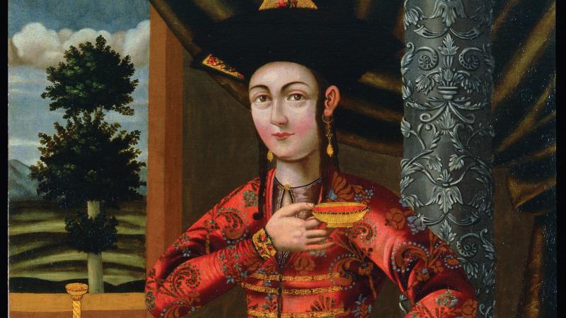 The Young Woman in a Georgian Costume; she is dressed in rich red and gold robes, with heavy gold earrings, holding a golden bowl above her chest