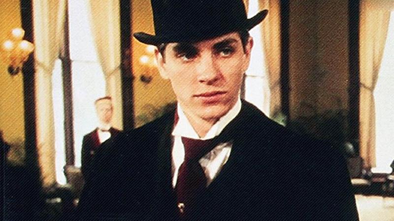 film still of a man in a suit and top hat