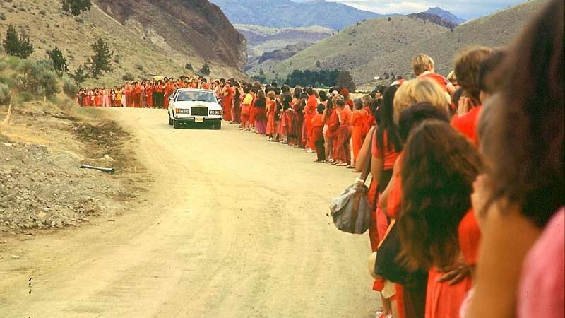 Bhagwan Shree Rajneesh drives by his followers