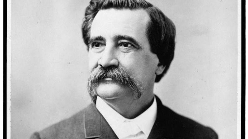 black and white portrait of a man with an impressive mustache