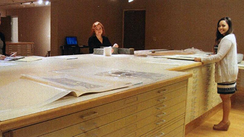 photo of women working on large table 