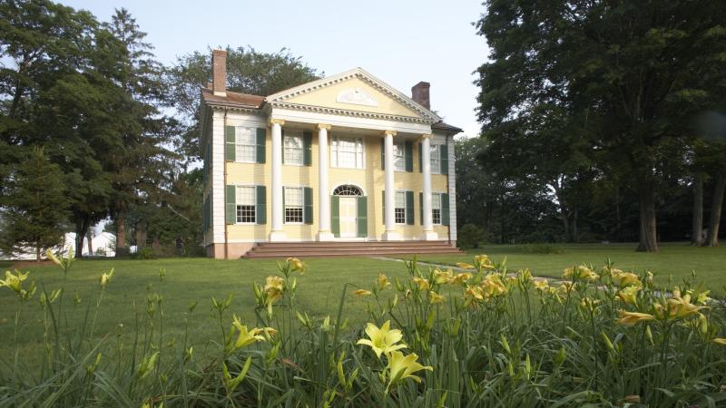 Photo of a restored mansion in a field of grass