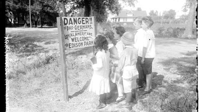 Children Standing in front of an anti-German sign posted in Edison Park.
