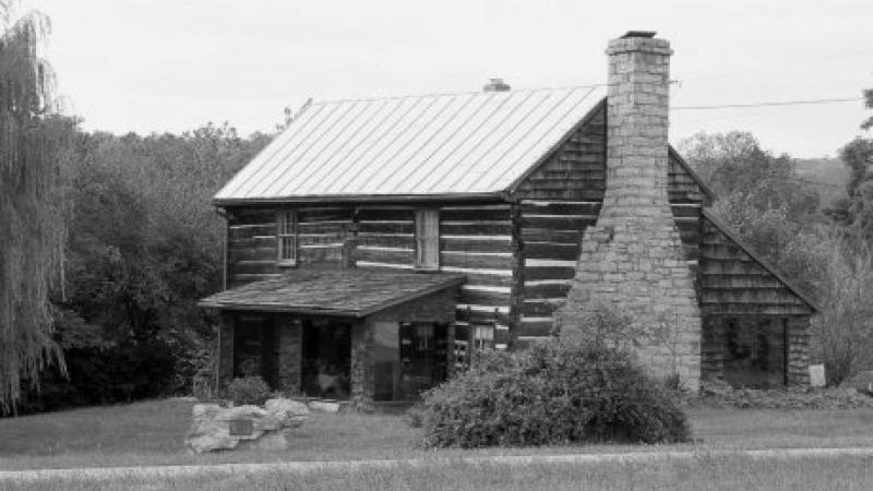 black and white photo of a log cabin