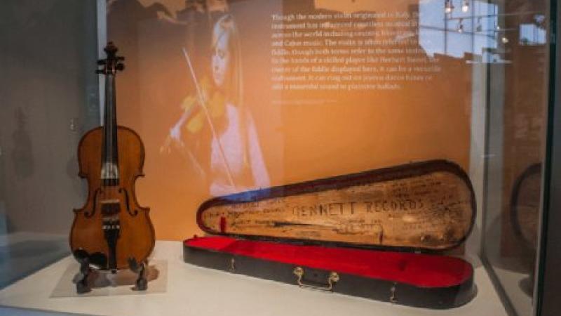 photo of a fiddle in a glass case