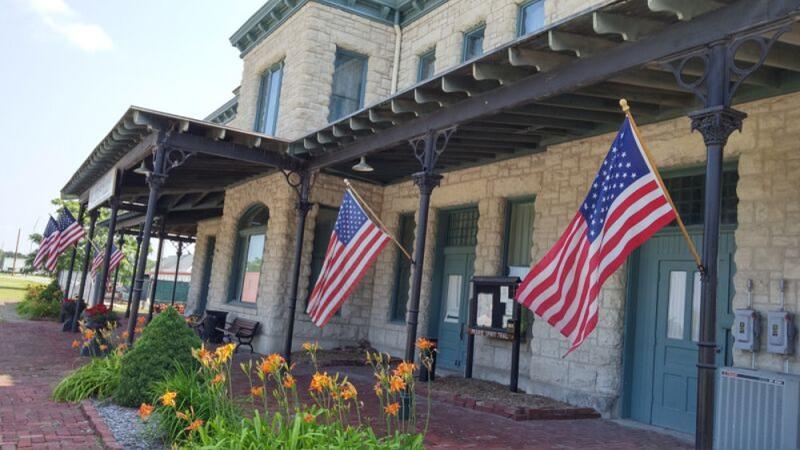 photograph of building exterior, flags flying