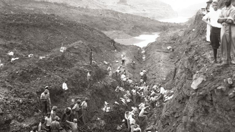 Black and white photo of men working on the Panama Canal.