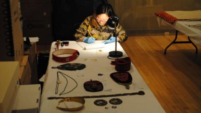 woman working at table with jewelry