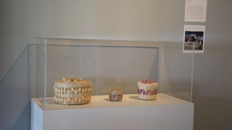 photo of woven baskets in a glass case