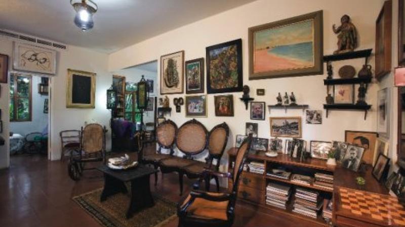 photograph of a room with pictures and artifacts on walls