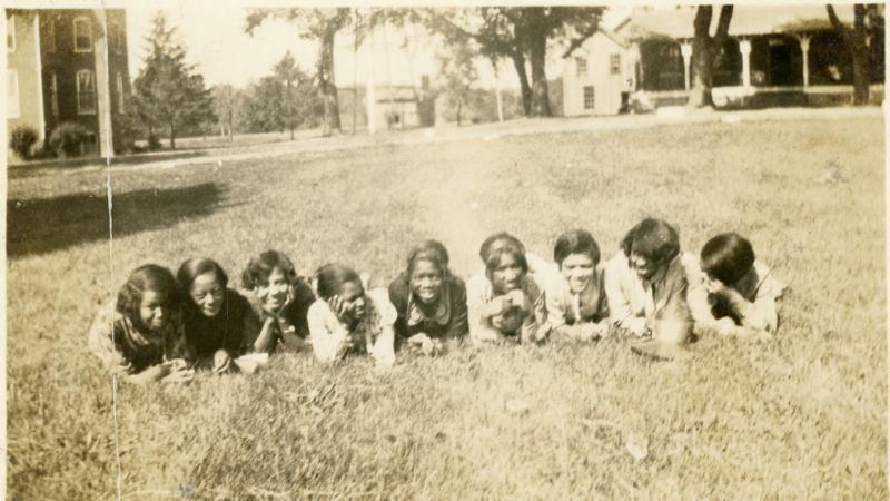 Early campus photograph of girls in the grass