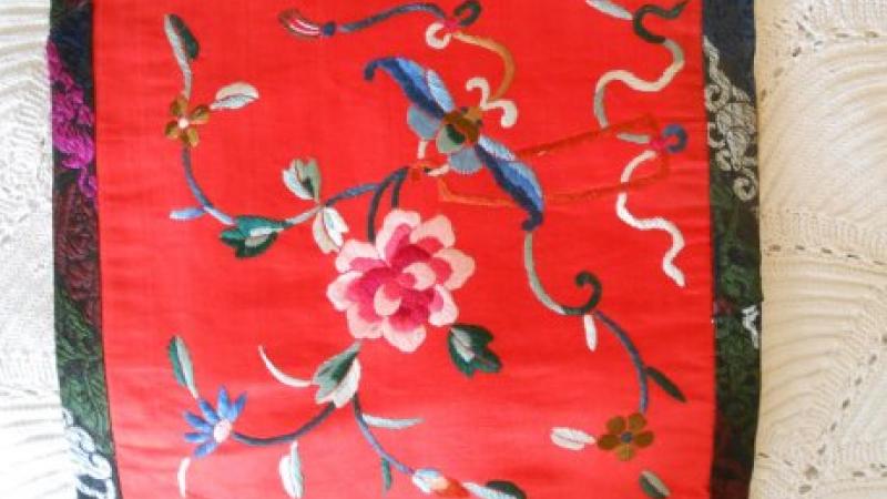 photograph of red embroidered fabric