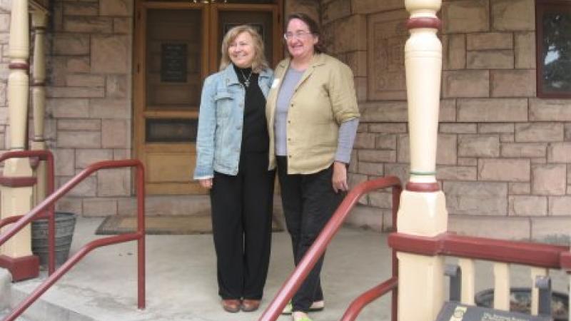 photograph of two women standing on porch