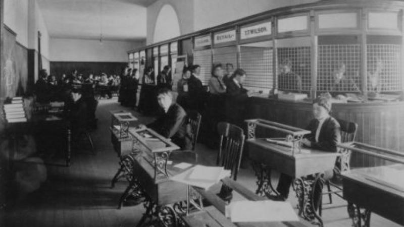 black and white photo of students working at desks