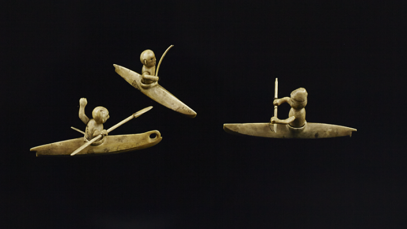 Ivory battle scene from the Kuskokwim, three men in small canoes