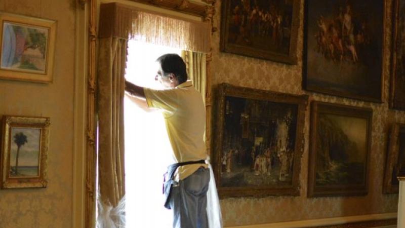 Applying film in Flagler's Music Room