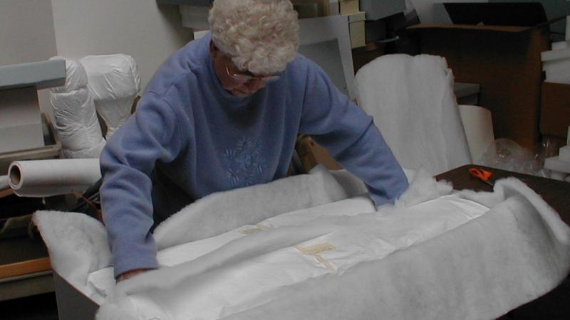 woman packing up archival materials