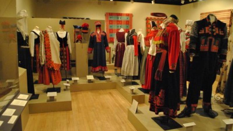 photograph of gallery room with costumes on mannequins