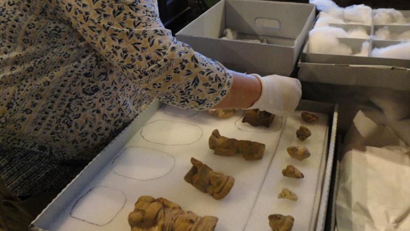 woman packing up artifacts