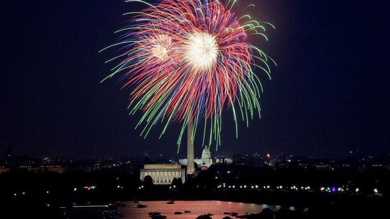 An explosion of fireworks against the night sky above the national mall in Washington, D.C.