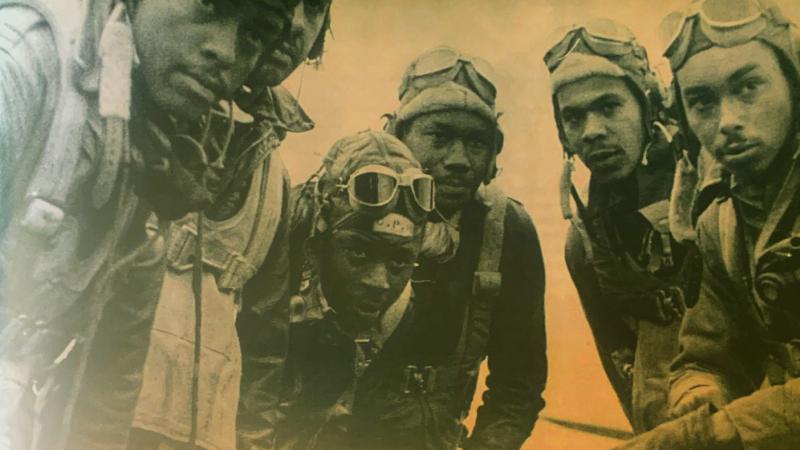 Black and white photo of six Tuskegee Airmen in Italy. 