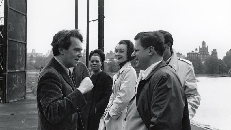 Black and white photo of Joe Papp left, with several people talking outside