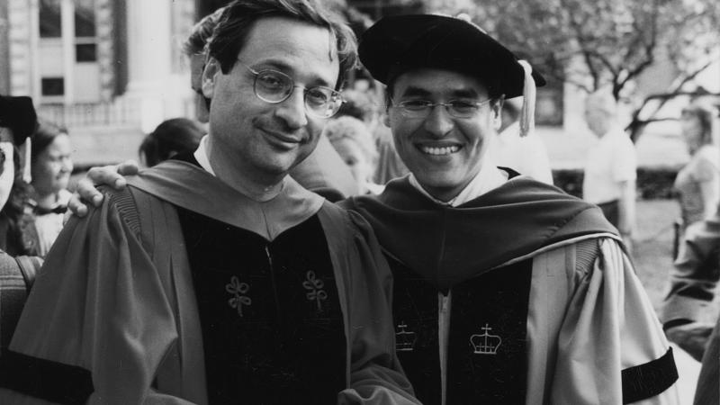 black and white photo of two professors in robes during a graduation ceremony