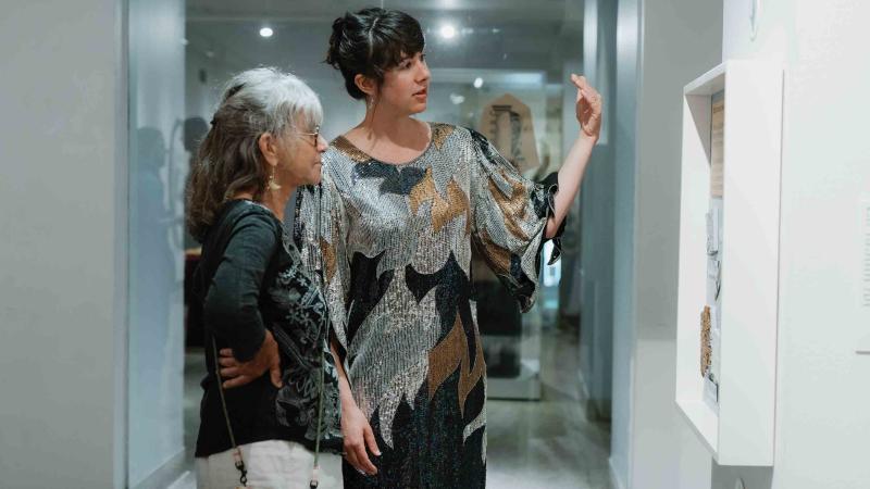 two women looking at art in a gallery