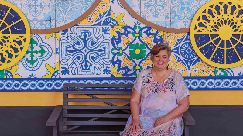 woman in front of colorful tiled wall in Puerto Rico