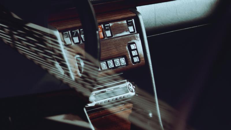Photograph of a dashboard and glove compartment in an older car.