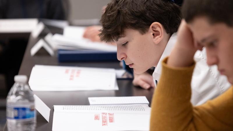 photograph of student reading booklet 